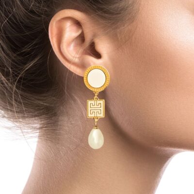 This collection is inspired by ancient Greek jewelry with a modern vision. You'll turn heads with these elegant Grecian earrings. A fine gold-plated meander with a beautiful cream enamel finish and a dangling pearl, hanging from a smooth ivory gold framed stud, is what makes these earrings unique. You can wear them all day or for a formal event.