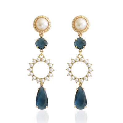 Enhance your look with these sophisticated and timeless earrings, featuring a duo of exquisite deep blue crystals (one round and one drop-shaped) adorning a golden circle embellished with pearls. A hammered gold frame encases the pearl stud, adding to its appeal. These earrings are a great choice for weddings or other formal events.